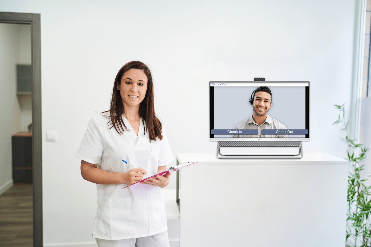 Medical receptionist standing right beside the kiosk