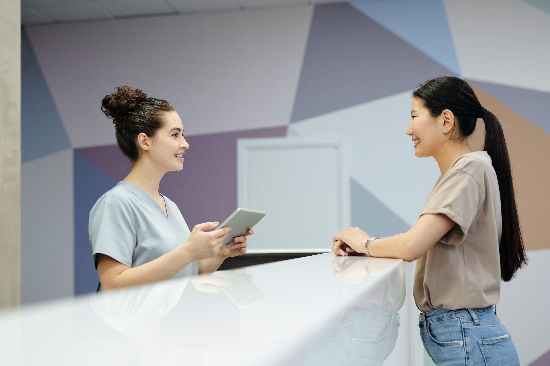 nurse-and-patient-in-medical-office-reception Nurse and patient in medical office reception