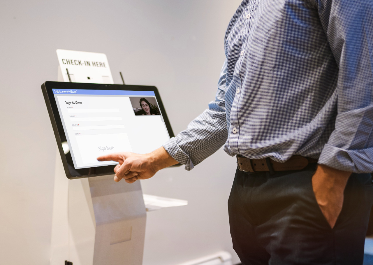 woman answering questions on the virtual front-desk receptionist kiosk machine