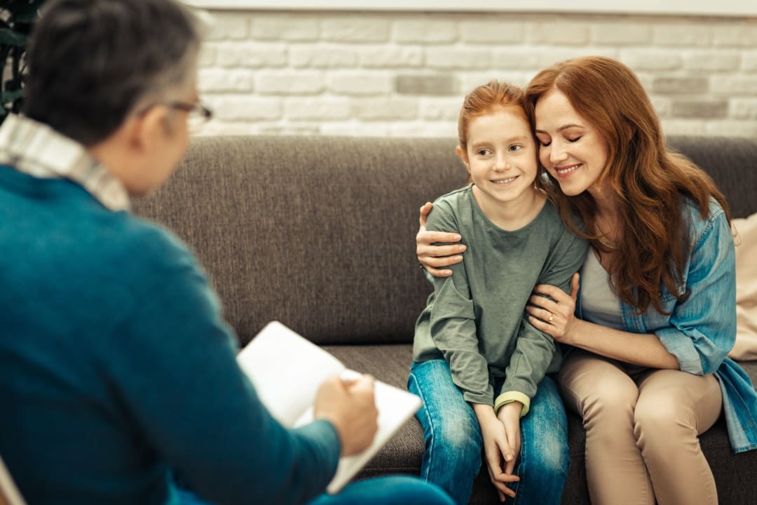 Therapist facilitating positive patient experience with child and parent