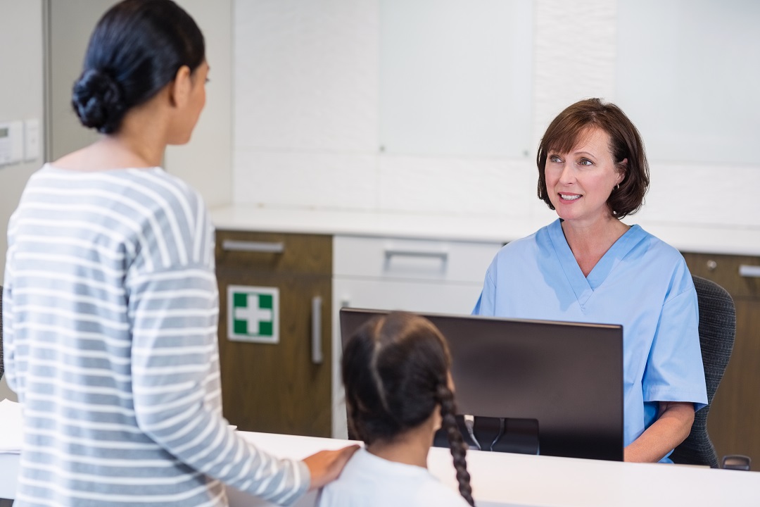 Medical receptionist accommodating patient and parent facilitating positive patient experience for front desk performance