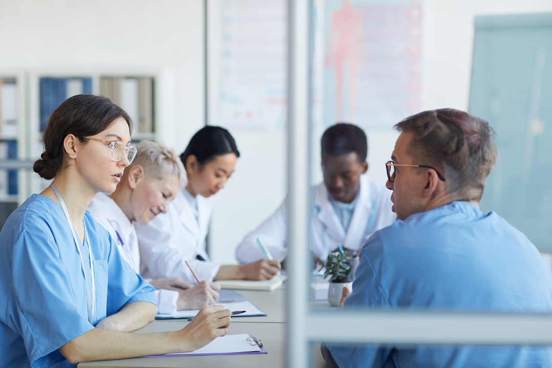 Medical training with healthcare receptionist listening to manager to improve front desk performance